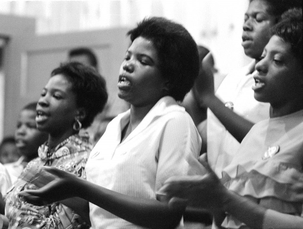 Young women singing freedom songs in a Selma church. 7/8/1964. Photo by Matt Herron/Take Stock Photos.